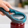 Hand using jar opener in kitchen Jar opener grip close up